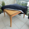fabric protection cover in black on a patio table