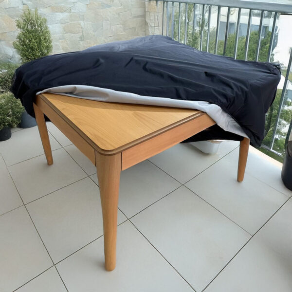fabric protection cover in black on a patio table