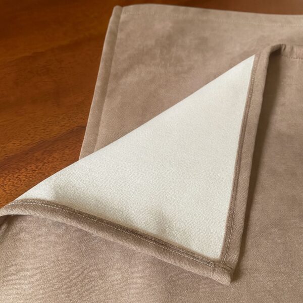 Close up of microfiber suede fabric with stitched overlocked edges
