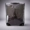 Backview of the Clear heavy-duty PVC luggage cover with all-around zipper protecting suitcase from rain and dust