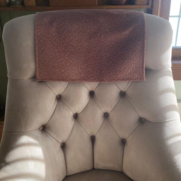 Decorative tan fleece headrest cover on modern sofa