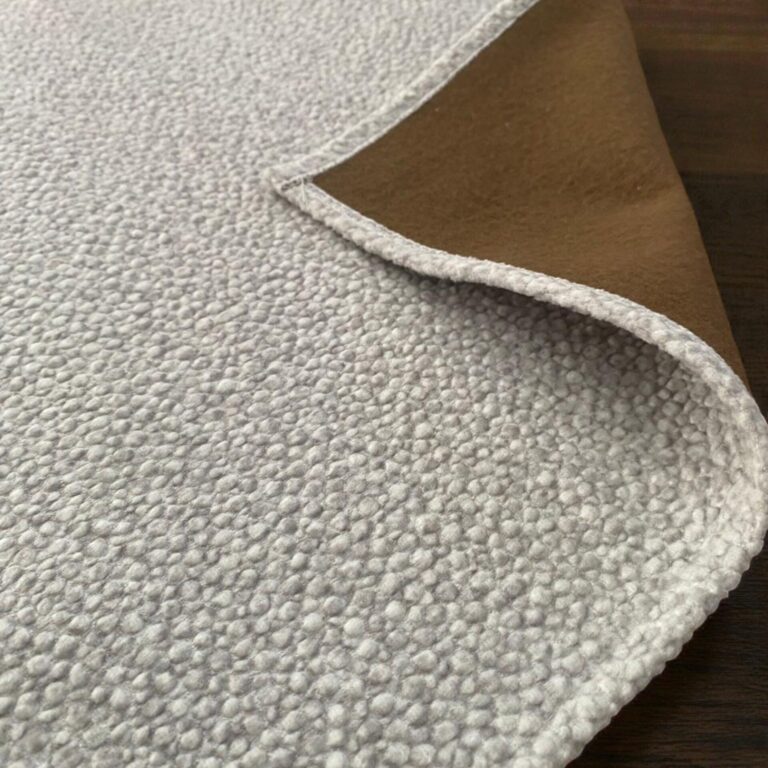 Close up image of the offwhite wear resistant fabric sofa cover